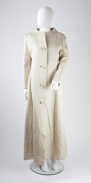 Appraisal: A full length Bonwit Teller cream evening coat with light