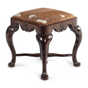 Appraisal: A George II Carved Walnut Footstool with Cowhide Upholstery th