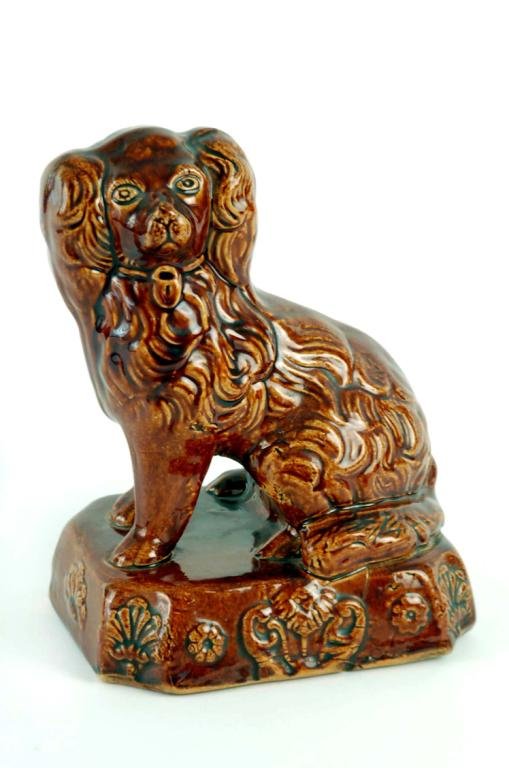 Appraisal: A Bennington pottery figure of a spaniel sitting on rectangular