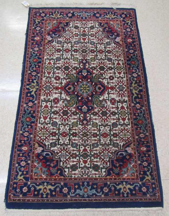 Appraisal: A CONTEMPORARY PERSIAN AREA RUG central floral cruciform medallion and