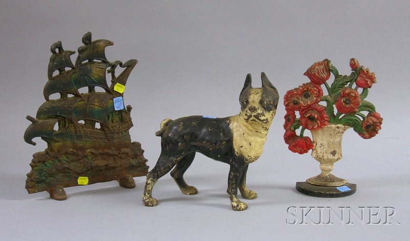 Appraisal: Three Painted Cast Iron Doorstops a Boston terrier sailing ship