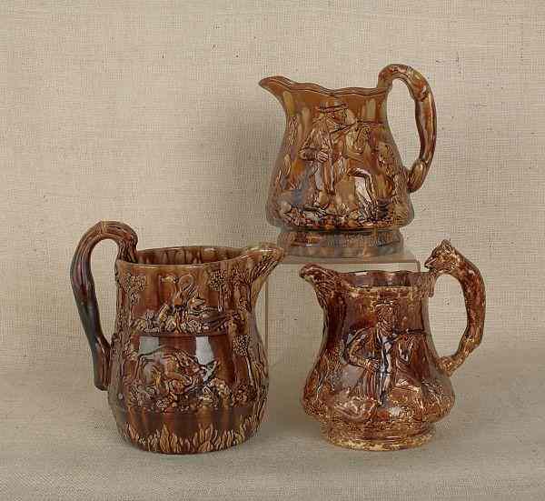 Appraisal: Three Rockingham glaze pitchers th c with hunt scenes and