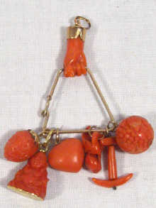 Appraisal: A Victorian high carat gold and coral charm pendant a