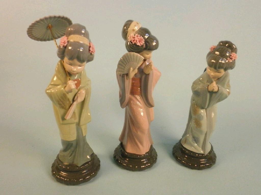 Appraisal: Three Lladro porcelain figures of Japanese ladies one holding a