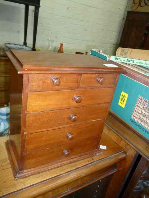 Appraisal: A MINIATURE MAHOGANY CHEST of two short and four long