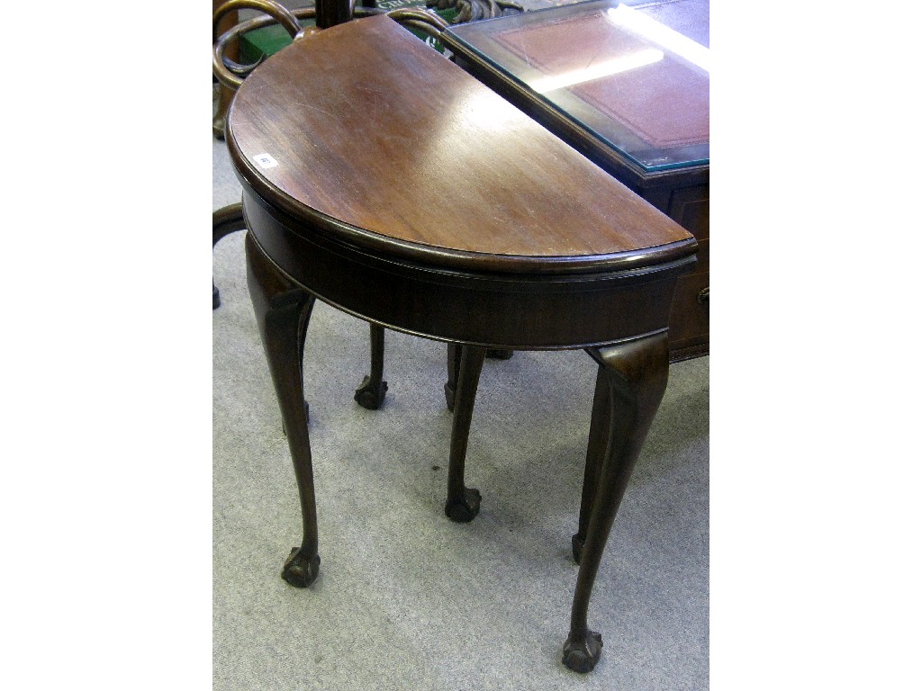 Appraisal: Mahogany demi lune fold over card table on ball and