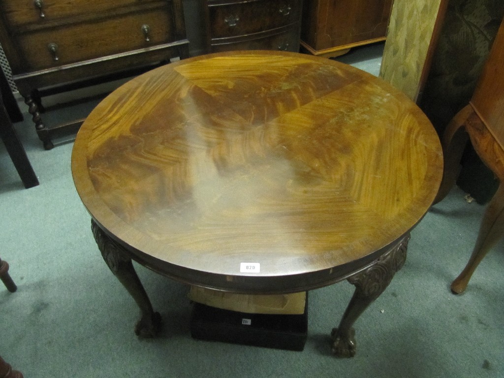 Appraisal: Mahogany circular coffee table raised on ball and claw supports