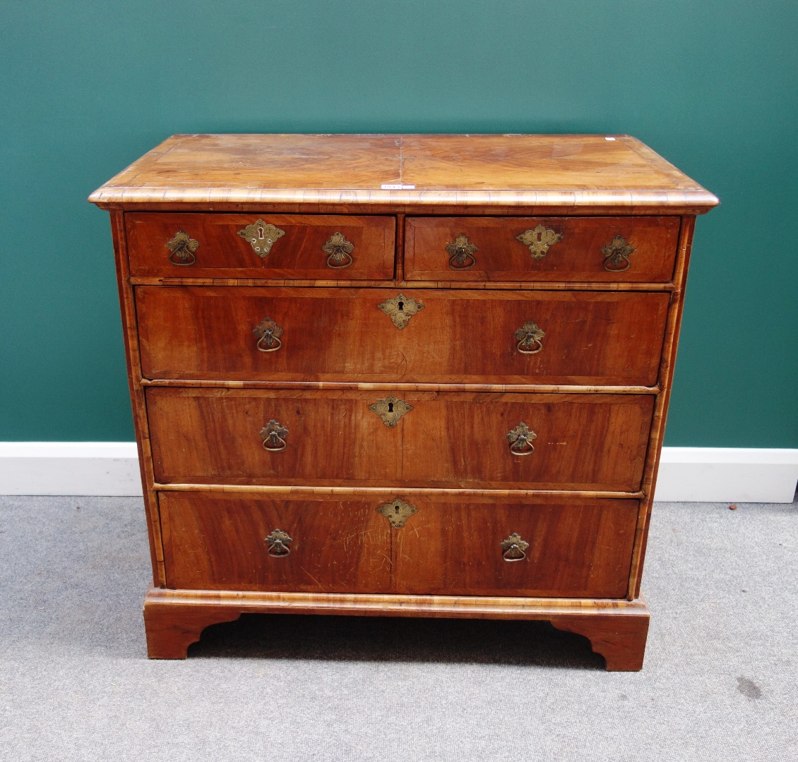 Appraisal: An early th century crossbanded walnut chest of two short