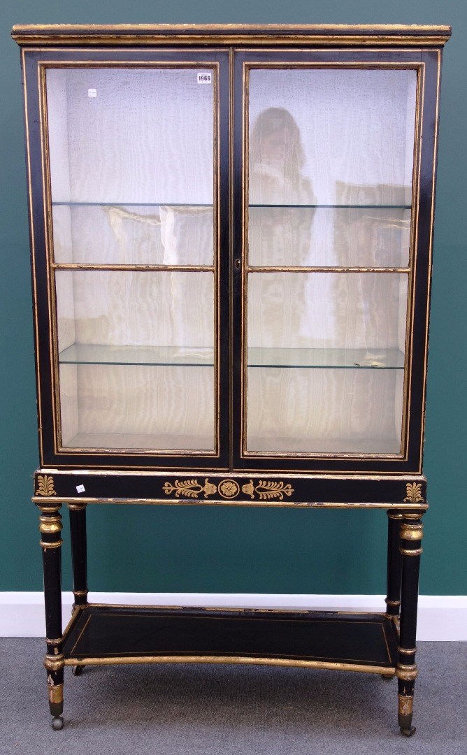 Appraisal: A made-up Regency black painted parcel gilt glazed two door