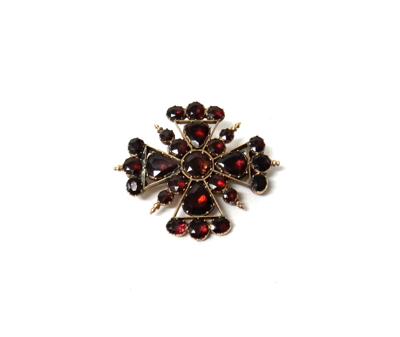 Appraisal: A garnet brooch in a Maltese cross shaped design mounted