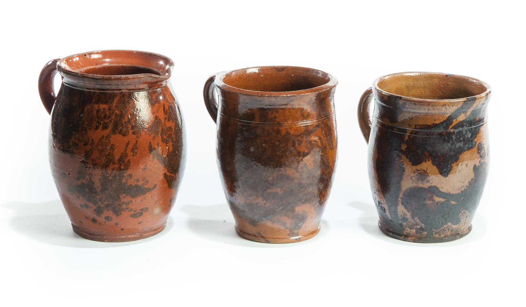 Appraisal: THREE AMERICAN REDWARE JARS Nineteenth century Applied handles and incised