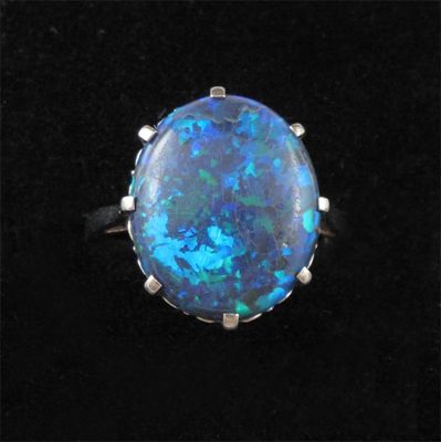 Appraisal: An opal ring The oval shaped solid black Lightning Ridge