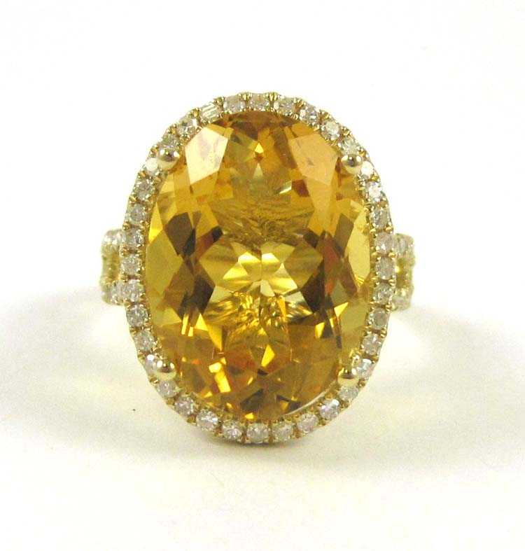 Appraisal: CITRINE DIAMOND AND FOURTEEN KARAT GOLD RING oval cut citrine