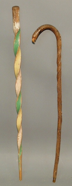 Appraisal: Carved eagle head cane l and a colorful twist carved