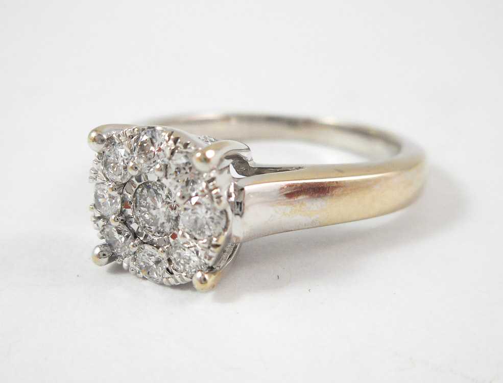 Appraisal: DIAMOND AND TEN KARAT WHITE GOLD RING set with nine