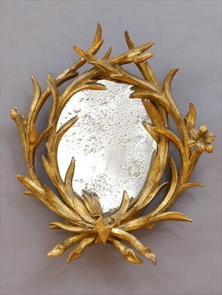 Appraisal: CONTINENTAL CARVED AND GILT MIRROR The naturalisticly carved frame with