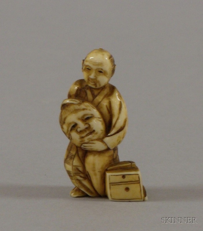 Appraisal: Ivory Netsuke standing figure of a man holding a mask