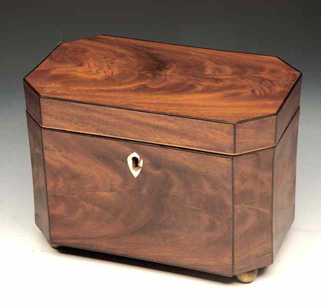 Appraisal: A GEORGE III MAHOGANY EIGHT SIDED TEA CADDY with twin