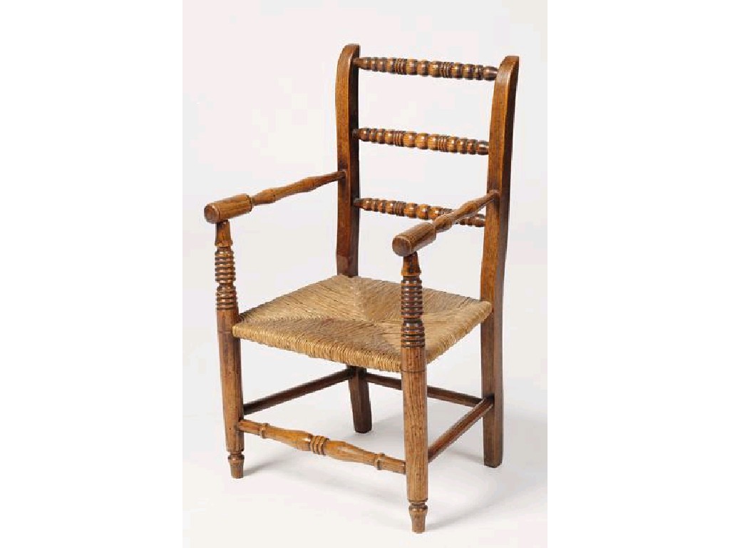 Appraisal: A CHILD'S TURNED RUSH SEATED ARMCHAIR the back with three