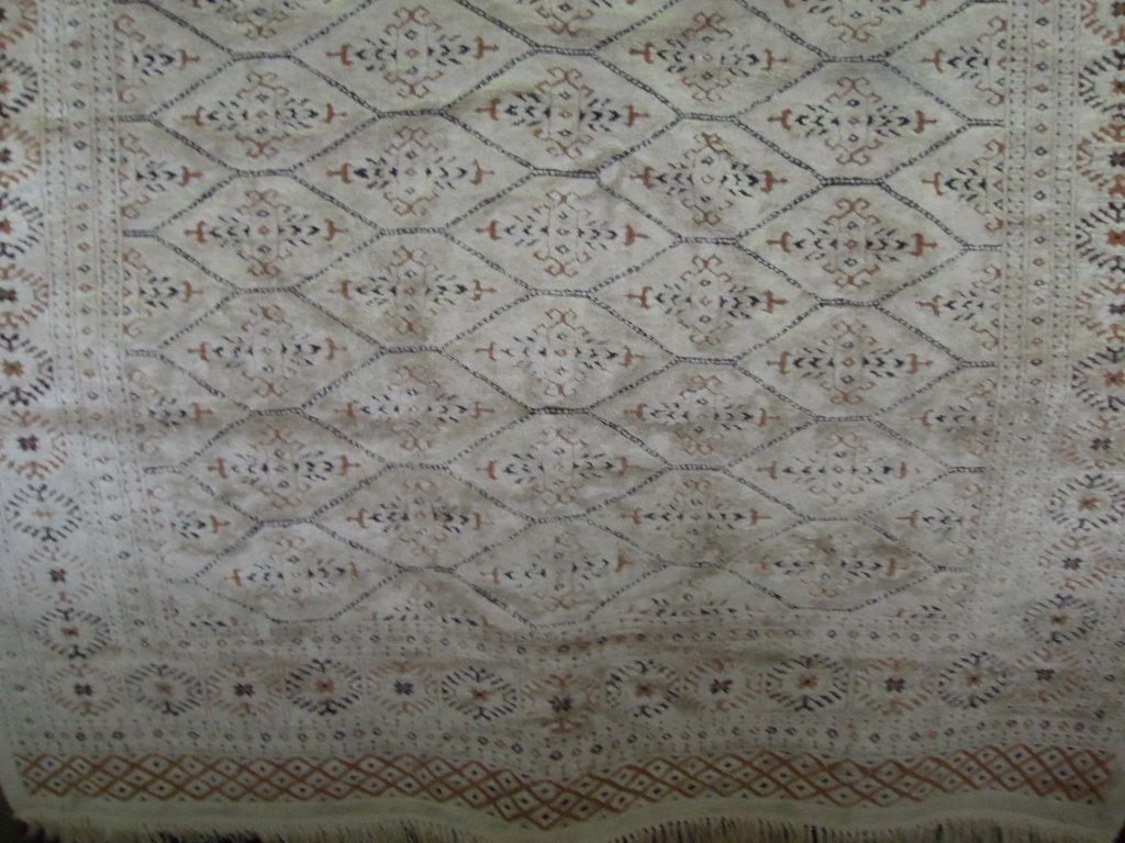 Appraisal: A silk effect cream rug with an overall geometric lozenge