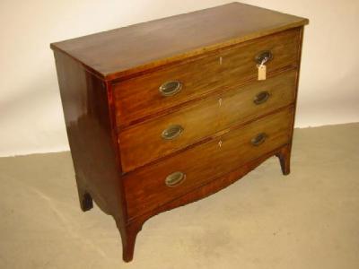 Appraisal: A MAHOGANY CHEST of three long cockbeaded drawers with oval