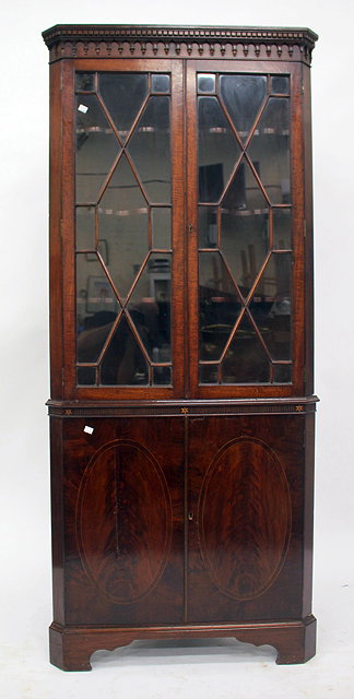 Appraisal: A TH CENTURY MAHOGANY CORNER CABINET with astral glazed doors