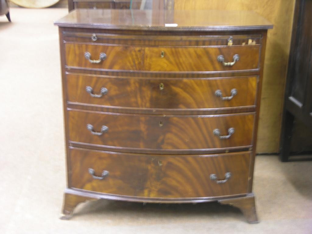 Appraisal: A bow fronted mahogany chest of four graduated drawers with