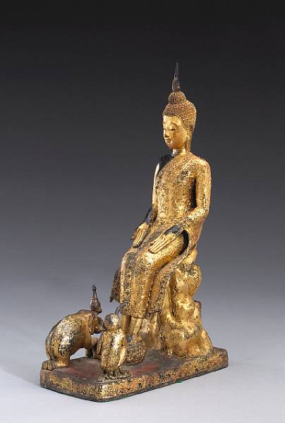 Appraisal: A Thai red and gilt lacquered bronze Buddha and animal