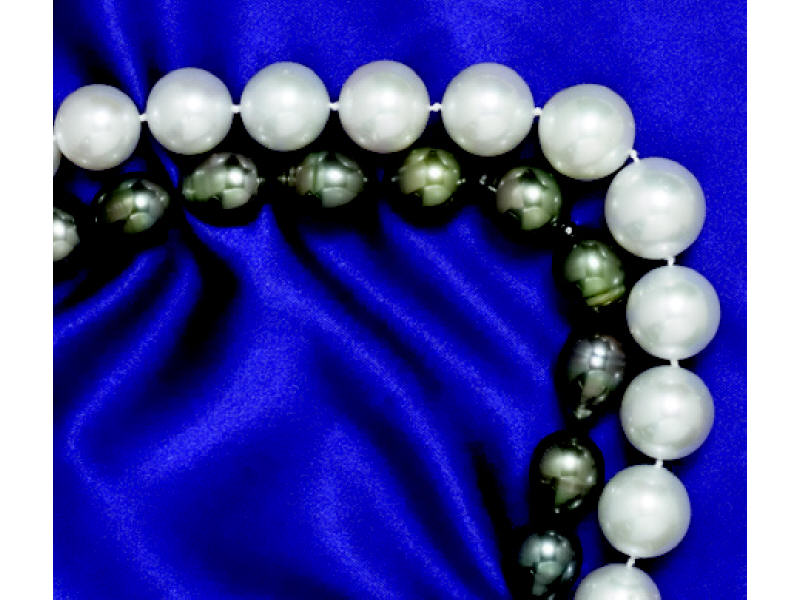 Appraisal: BLACK BAROQUE PEARLS With k white gold diamond barrel clasp