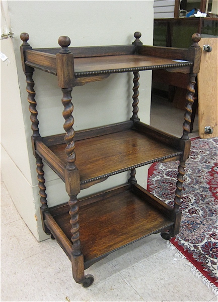 Appraisal: THREE TIER OAK PASTRY STAND ON CASTERS English c having