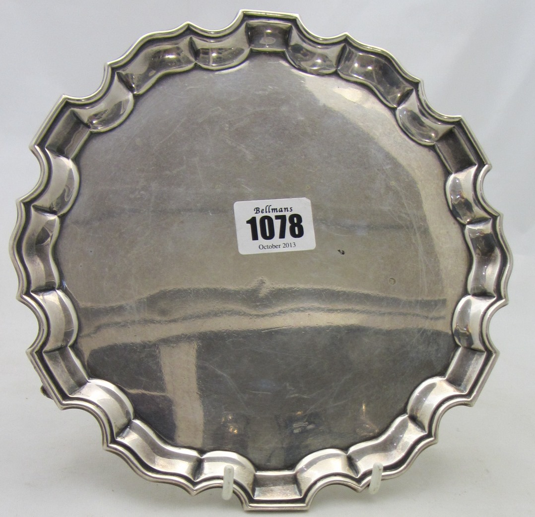 Appraisal: A silver shaped circular waiter with a Chippendale style rim