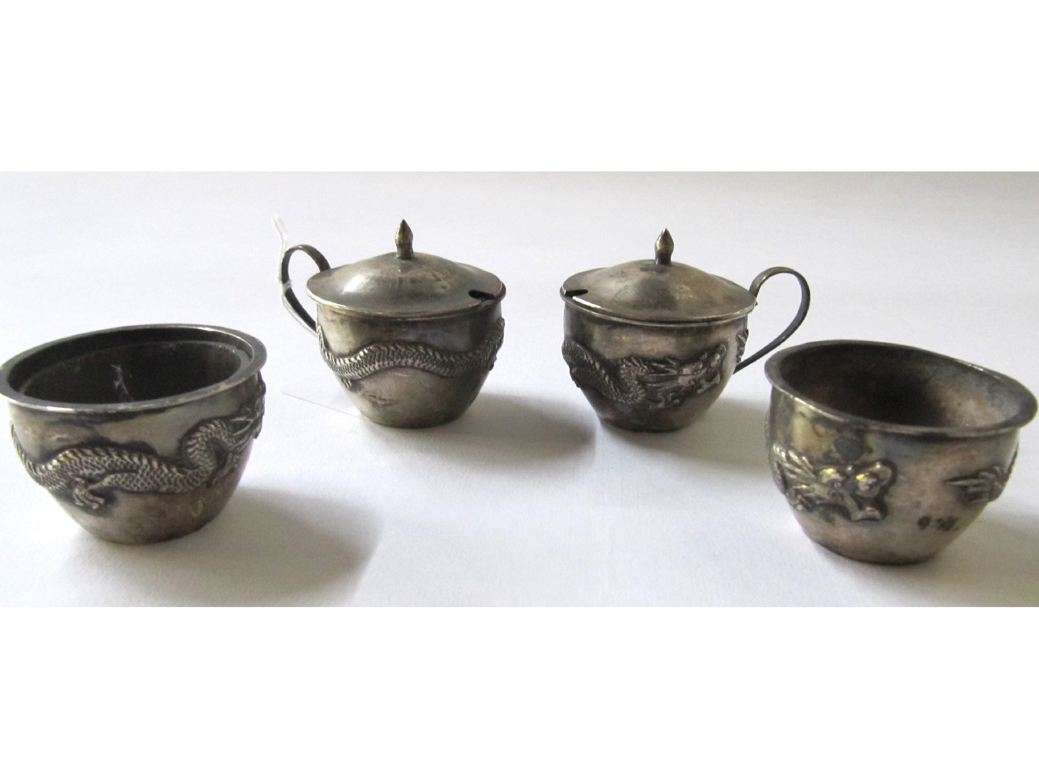 Appraisal: A pair of Chinese white metal mustard pots with a