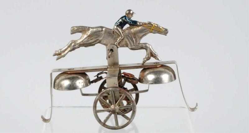 Appraisal: Tin Articulated Jockey on Horse Bell Toy American Tin spoke