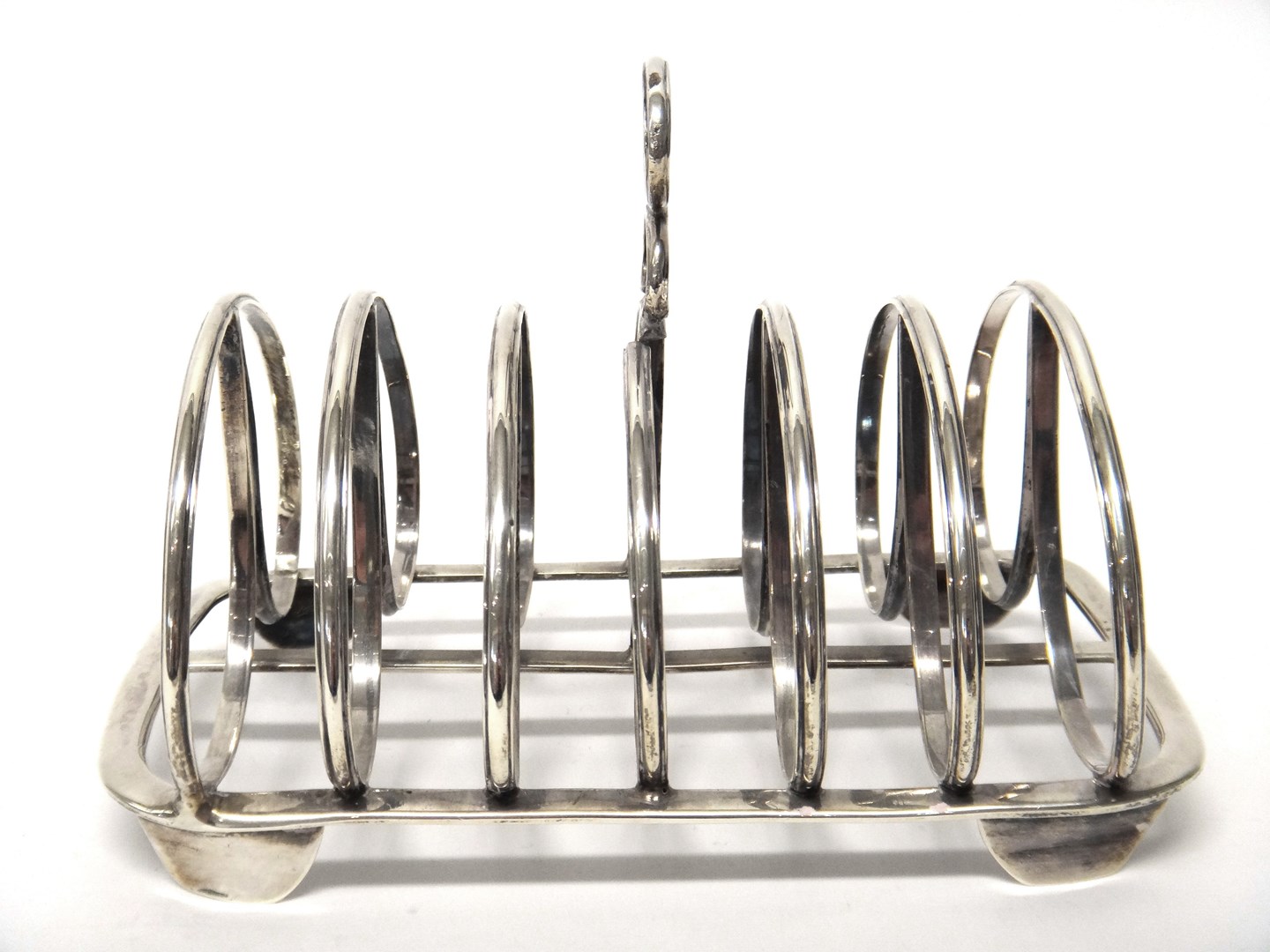 Appraisal: A William IV silver seven bar toastrack with a loop