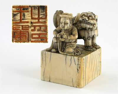 Appraisal: A Chinese ivory seal surmounted by a large Buddhistic lion