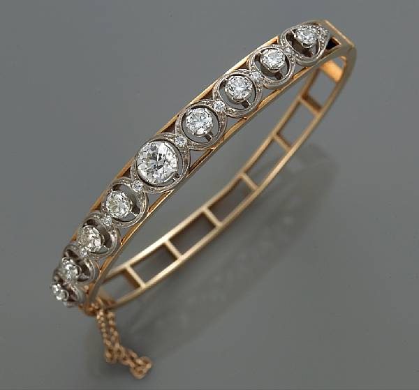 Appraisal: A diamond bangle bracelet centering a European-cut diamond weighing approximately