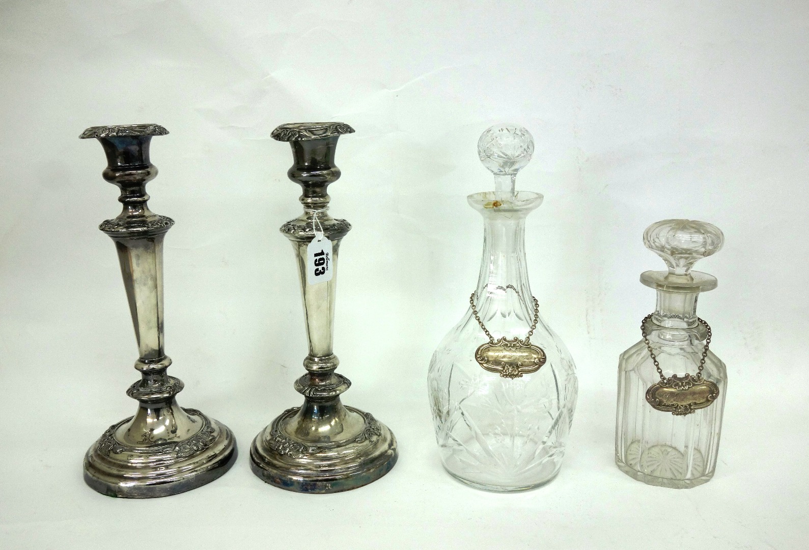 Appraisal: A pair of Victorian electroplate candlesticks with foliate borders and