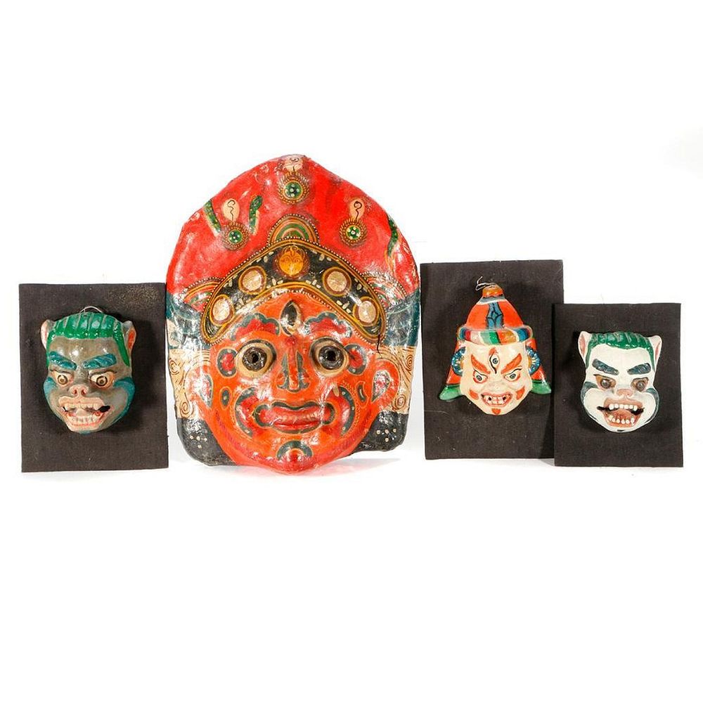 Appraisal: Four Nepalese masks Four Nepalese masks the largest measuring inches