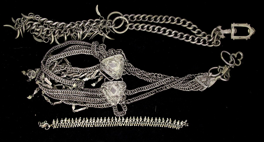 Appraisal: Two Eastern white metal neck chains hung with pendants and