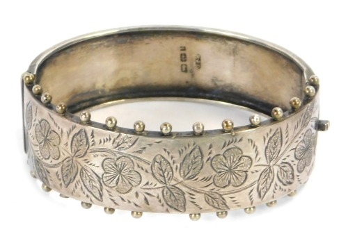 Appraisal: A Victorian silver hinged bangle the half engraved design of