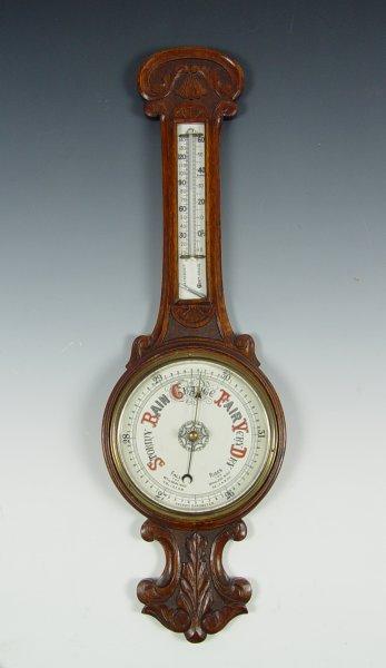 Appraisal: VICTORIAN CARVED OAK BAROMETER Aneroid wheel barometer with removable thermometer