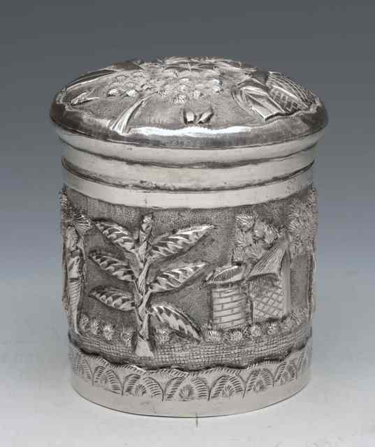 Appraisal: AN INDIAN SILVER CYLINDRICAL BOX embossed with figures huts and