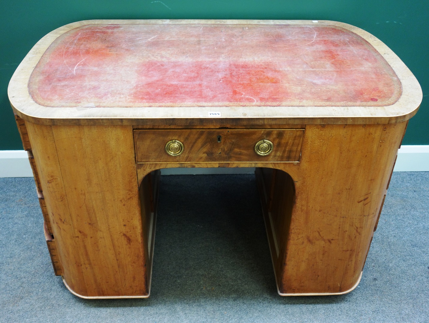 Appraisal: A th century oval mahogany kneehole writing desk with four