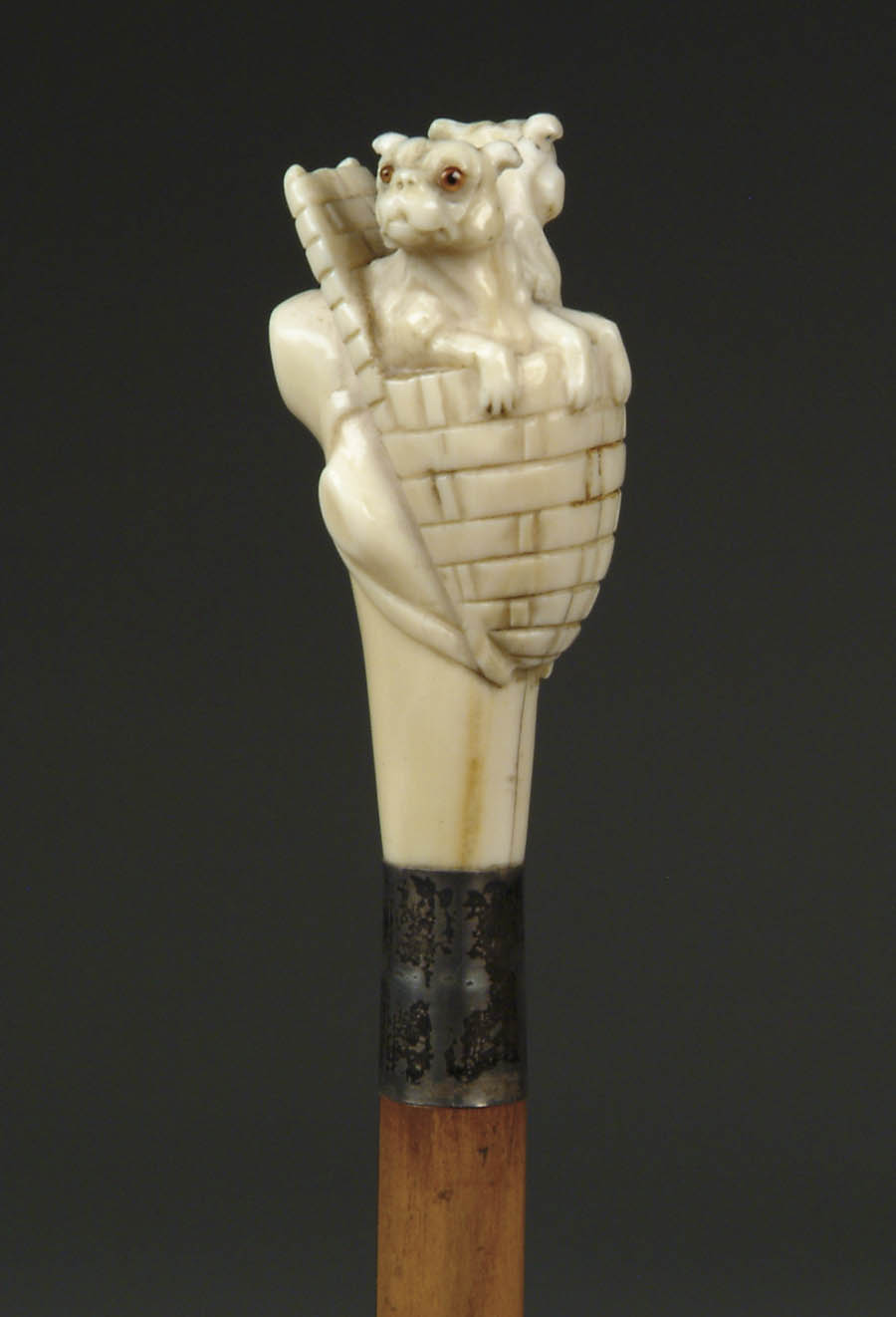 Appraisal: CARVED IVORY CANE OF TWO DOGS IN A BASKET Elephant