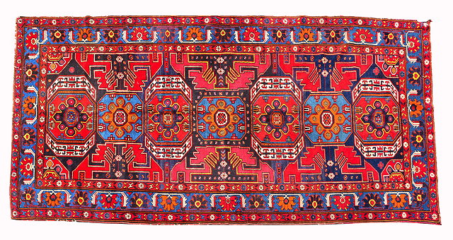 Appraisal: A CENTRAL ASIAN RED GROUND CARPET with all over polychrome