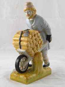 Appraisal: A Russian ceramic figure of a gardener pushing a barrow