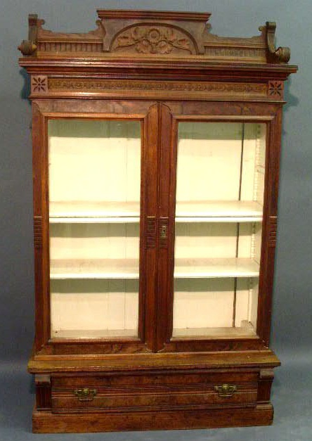 Appraisal: Victorian walnut bookcase with a galleried top and two glass