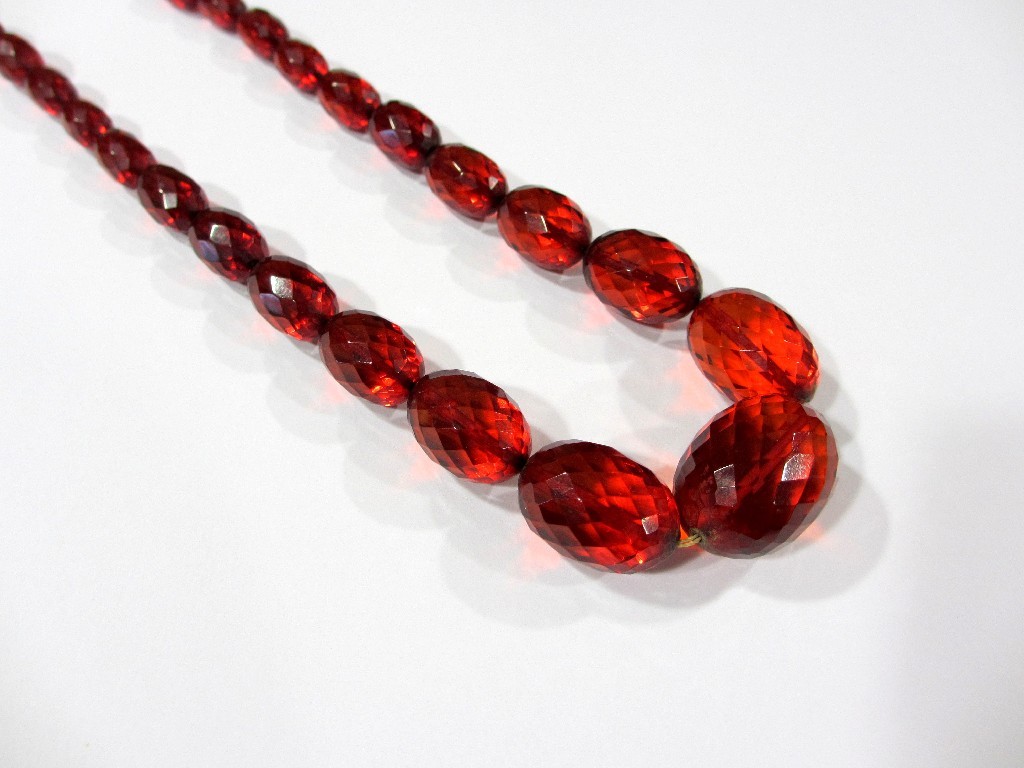 Appraisal: A long string of graduated amber beads faceted barley sugar