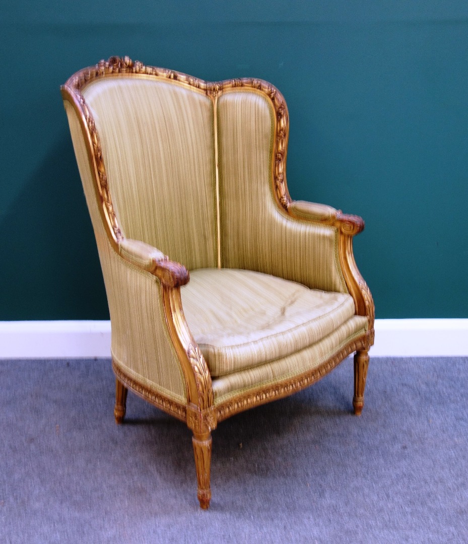 Appraisal: A Louis XVI style carved giltwood tub backed armchair with