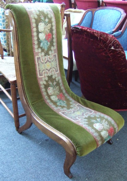 Appraisal: A Victorian walnut nuring chair with 'S' scroll seat and